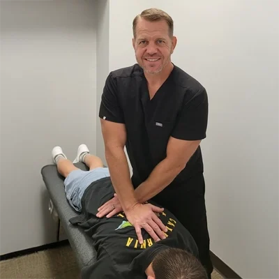 Dr. Jason Palmer adjusting a patient's back